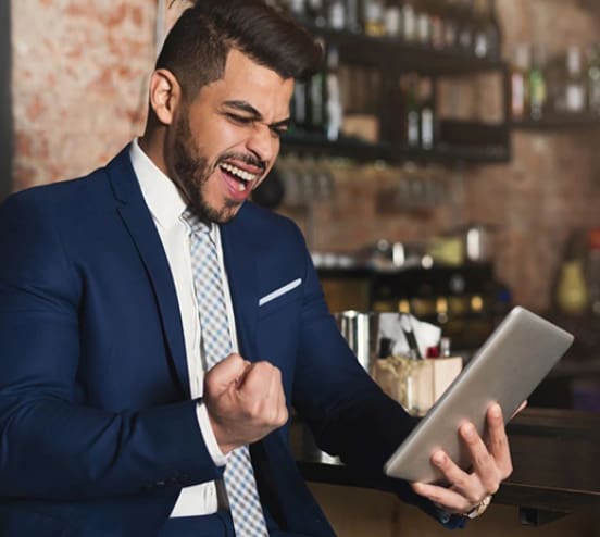 image - 2024-06-05T161045.754 A man in a suit and tie holding an ipad.